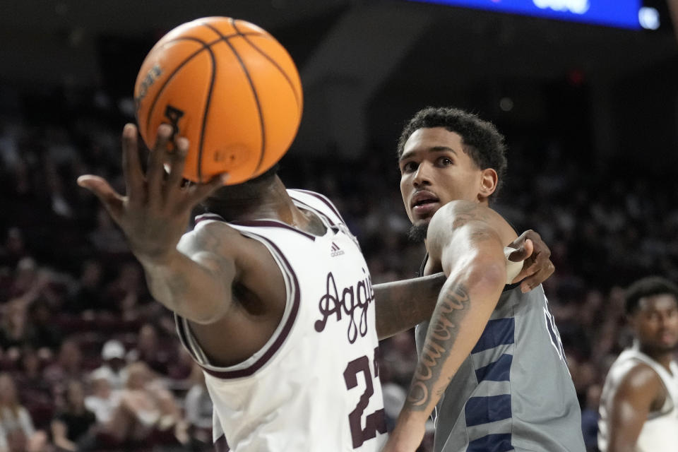 Texas A&M guard Tyrece Radford, left, fights for against Oral Roberts guard Jailen Bedford, right, during the second half of an NCAA college basketball game Friday, Nov. 17, 2023, in College Station, Texas. (AP Photo/Sam Craft)