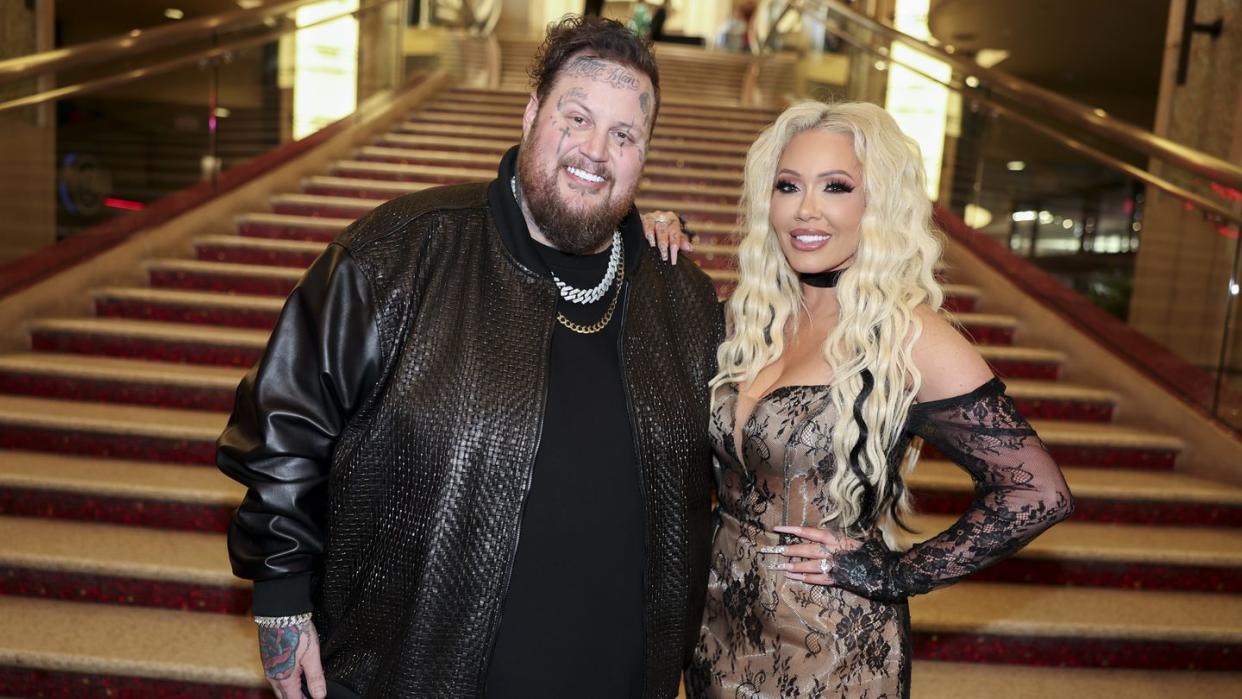 jelly roll and bunnie xo standing for a photo in front of a staircase