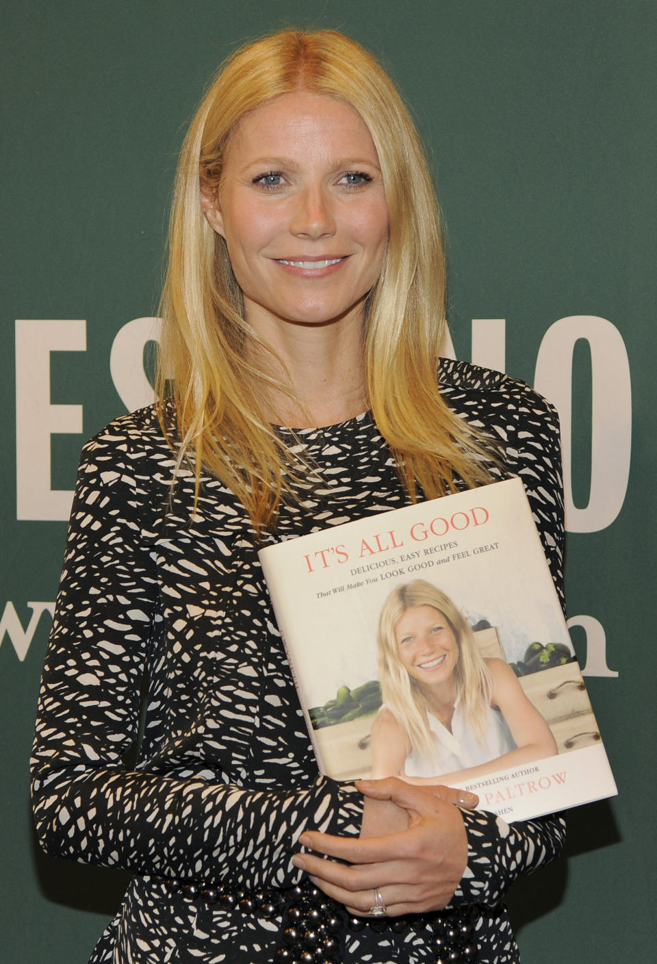 Gwyneth Paltrow poses with her new book "It's All Good: Delicious, Easy Recipes That Will Make You Look Good and Feel Great," before a signing at Barnes and Noble on Wednesday, April 3, 2013 in Los Angeles. (Photo by Chris Pizzello/Invision/AP)