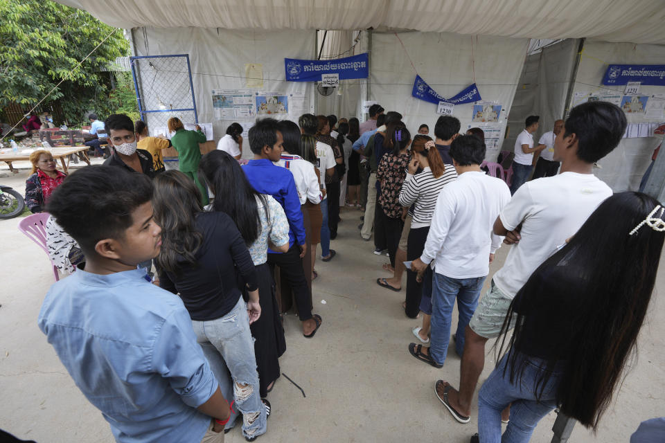 Locals line up for voting at a polling station at Krang Thnung village outside Phnom Penh, Cambodia, Sunday, July 23, 2023. (AP Photo/Heng Sinith)