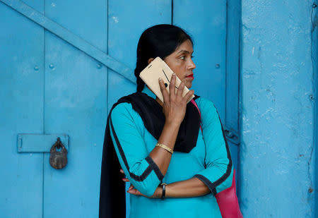 FILE PHOTO: A woman talks on her mobile phone on a pavement in Kolkata, India July 5, 2017. REUTERS/Rupak De Chowdhuri/File Photo