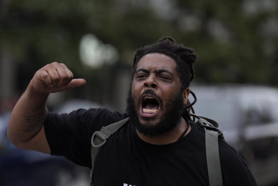 Dejaun Sharb chants while walking ahead of the Justice for Donovan Lewis protest and march Saturday in Columbus.