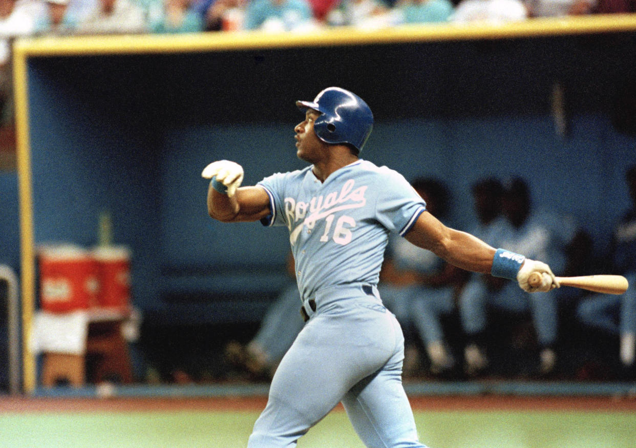 Kansas City Royal Bo Jackson watches his 26th home run of 1989 clear the fence in right field during second inning action against the Seattle Mariners in Seattle on Sunday, August 21, 1989. Kansas City Royals beat Seattle 5-4 completing a four-game sweep against the Mariners. (AP Photo/Jim Davidson)