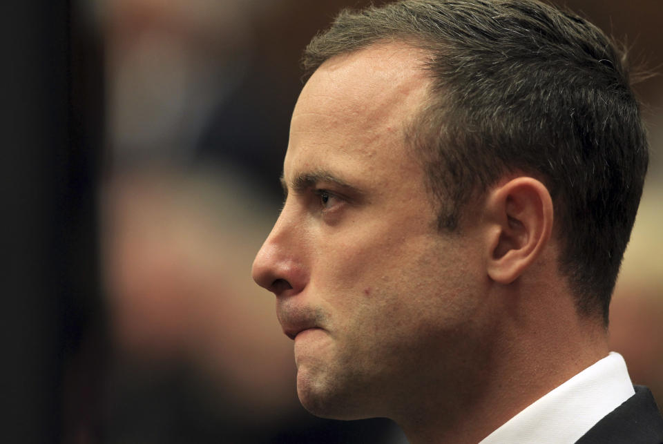 Oscar Pistorius stands in court shortly after arriving for his trial at the high court in Pretoria, South Africa, Monday, March 3, 2014. Pistorius is charged with murder with premeditation in the shooting death of girlfriend Reeva Steenkamp in the pre-dawn hours of Valentine's Day 2013. (AP Photo/Themba Hadebe, Pool)