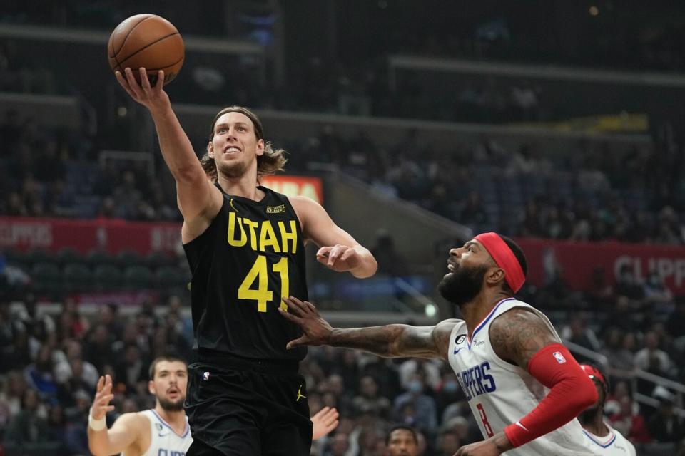 Utah's Kelly Olynyk goes up a shot in front of Clippers forward Marcus Morris Sr. during the Clippers' loss Sunday.