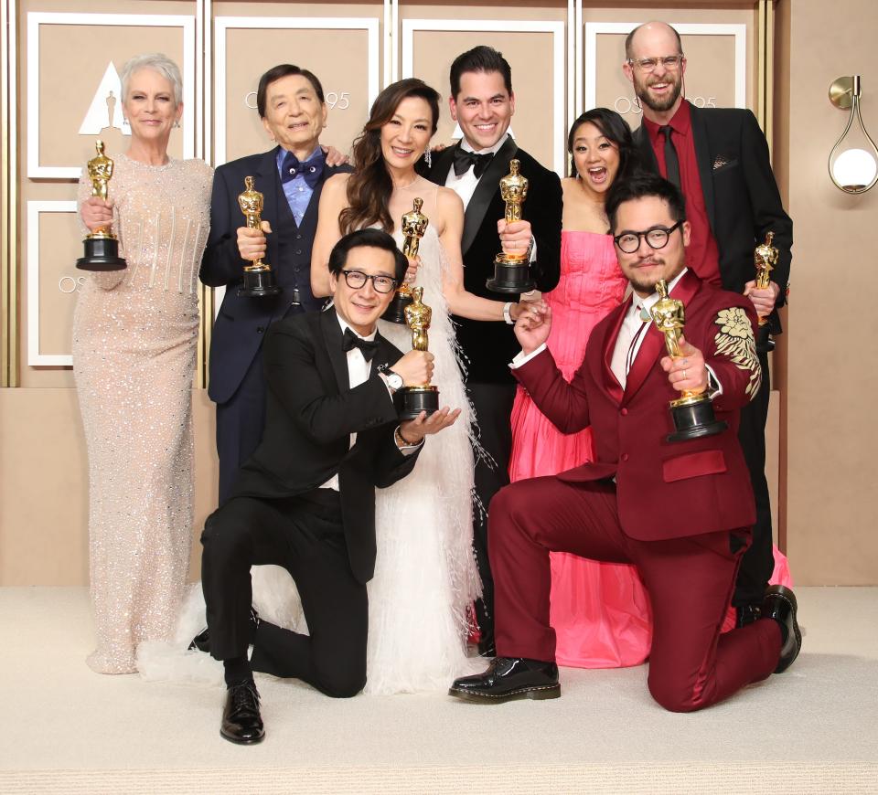 (L-R top row) Jamie Lee Curtis, James Hong, Michelle Yeoh,  Jonathan Wang, Stephanie Hsu, Daniel Scheinert, and (L-R bottom row) Ke Huy Quan and Dan Kwan pose after "Everything Everywhere All at Once" wins best picture.