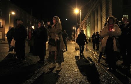 People hold candles during a vigil in memory of Savita Halappanavar and in support of changes to abortion law in Dublin November 17, 2012. A wave of protests have taken place across Ireland in recent days in response to the death of 31-year old Halappanavar who died of septicaemia following a miscarriage 17 weeks into her pregnancy. REUTERS/Cathal McNaughton