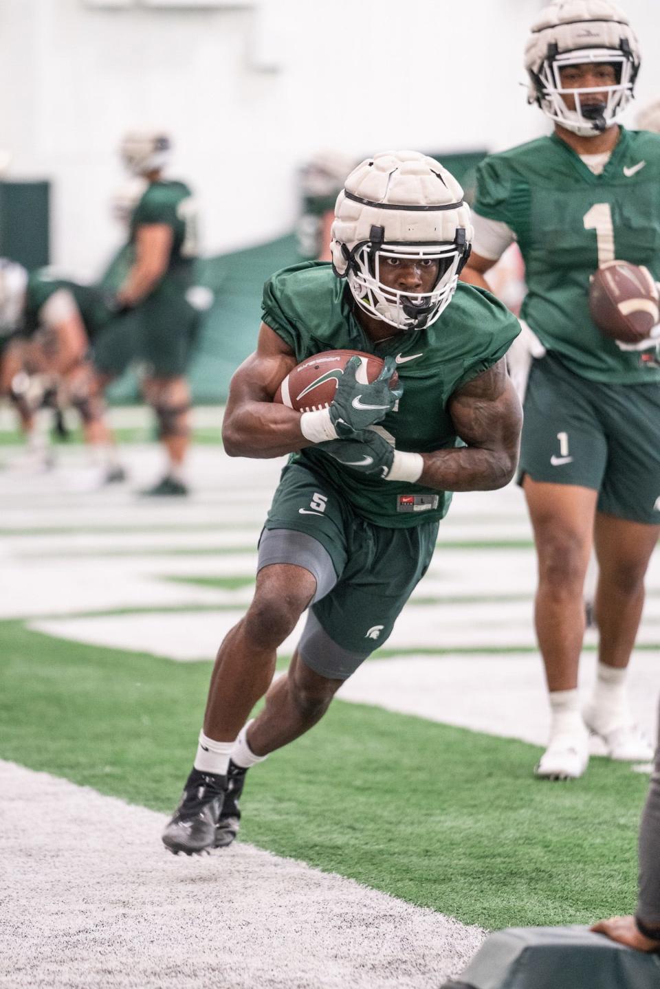 Michigan State running back Nathan Carter goes through drills on Tuesday, March 28, 2023, in East Lansing.
