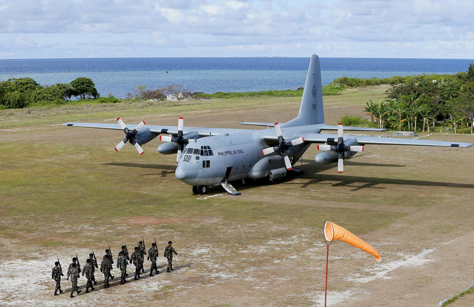 Philippine troops march to greet officials