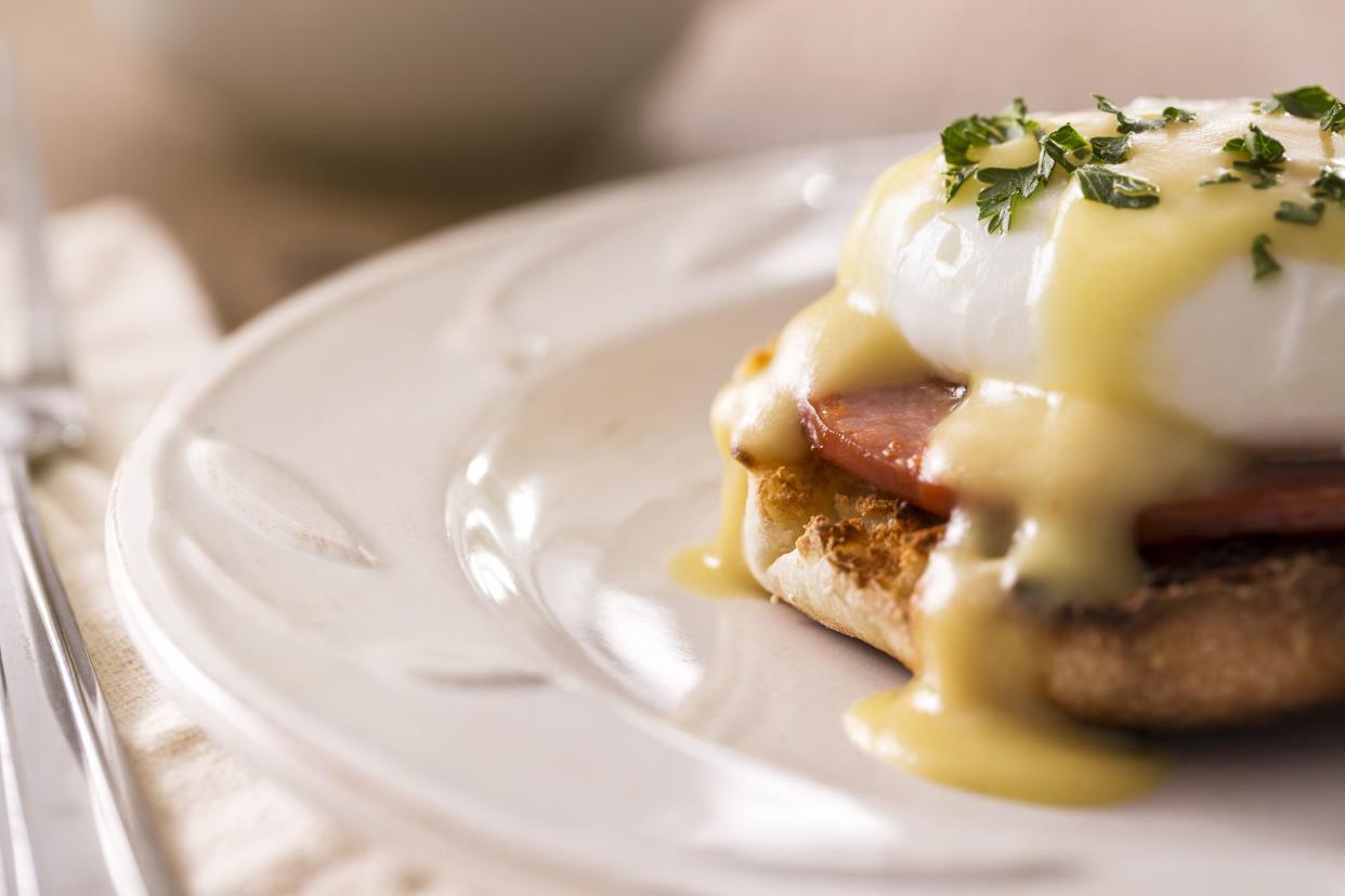 Morning Breakfast - Eggs benedict with hollandaise sauce.  Eggs benedict is a dish made with a poached egg, ham, and toasted english muffin with hollandaise sauce on top.  Please see my portfolio for other food and drink images.