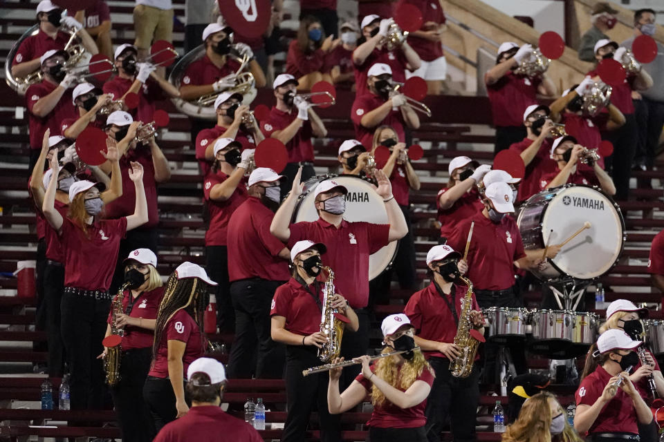 FILE - In this Saturday, Sept. 12, 2020 file photo, a reduced size Oklahoma band performs in the stands in the second half of an NCAA college football game against Missouri State in Norman, Okla. Marching bands, part of the game since its beginning more than a century ago, are idled or toned down across the country. (AP Photo/Sue Ogrocki, File)