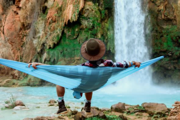 Man in hammock near water - Unsplash image