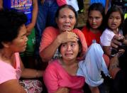 Residents who want to evacuate from their homes gather while waiting for a vehicle after Islamist militants, who had holed up in a primary school, retreated after a gunbattle with troops but were holding some civilians hostage, in Pigcawayan, North Cotabato, Philippines June 21, 2017. REUTERS/Marconi Navales