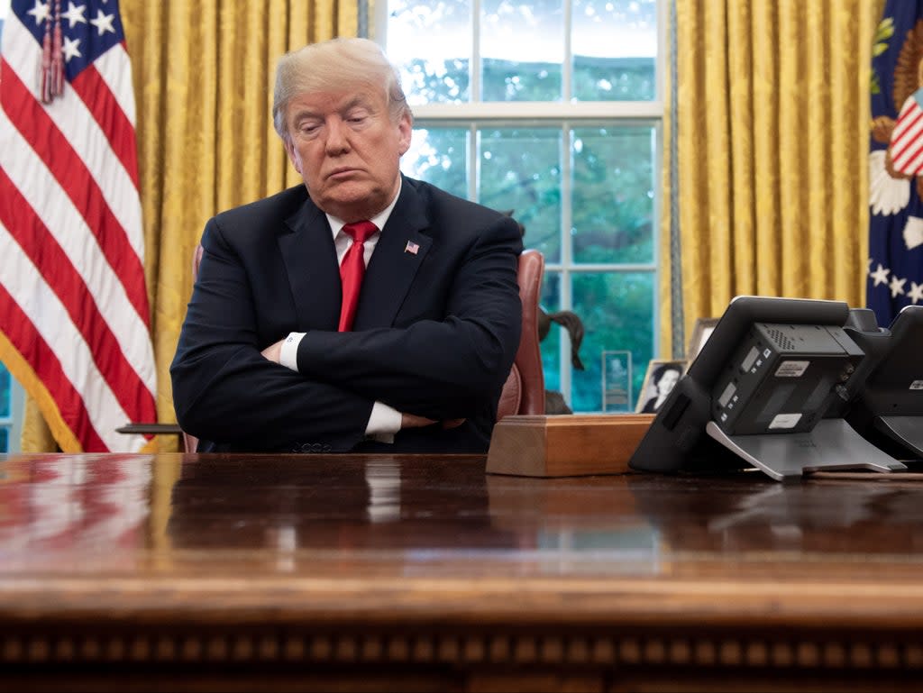 US President Donald Trump sits at the Resolute Desk during a briefing on Hurricane Michael in the Oval Office of the White House in Washington, DC, on 10 October 2018 ((AFP via Getty Images))