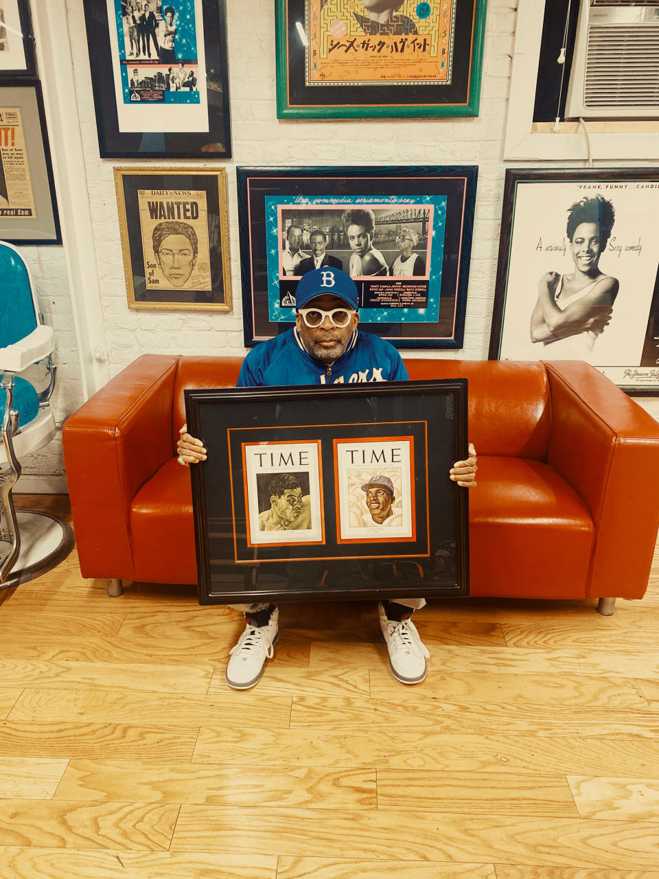 Lee in February with a game-worn Robinson jacket and two TIME covers—Robinson on the right—he displays at his Brooklyn office<span class="copyright">Braylen Dion for TIME</span>