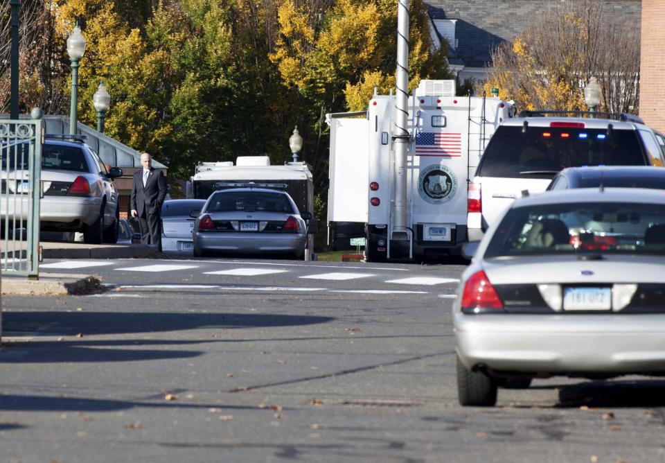 Law enforcement vehicles line the roadway to Central Connecticut State University while it is in lockdown in New Britain, Connecticut November 4, 2013. A person has been taken into custody at Central Connecticut State University on Monday after officials locked down the campus when a suspicious person, possibly armed, was spotted, said New Britain Mayor Tim O'Brien. Citing students, local media said police had searched for a person who appeared to be carrying a gun and what looked like a sword. (REUTERS/Michelle McLoughlin)