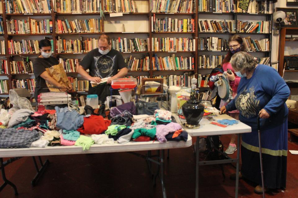 People shop at the Gainesville Free Store at the Civic Media Center located sat 433 S. Main St. on Nov. 20. The store is open every third Saturday of the month and features clothing, household goods, toiletries, small appliances, knickknacks and other items — all for free.