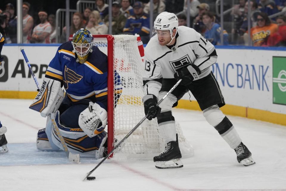 A goaltender crouches as the Kings' Gabriel Vilardi sweeps in from the side of the net.