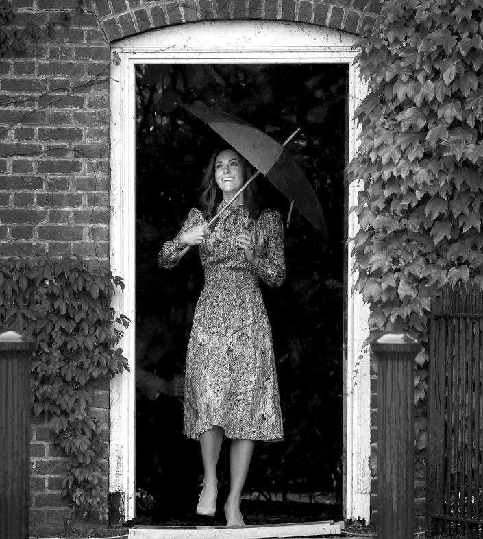 Kate Middleton holds an umbrella as she visits The Sunken Garden at Kensington Palace