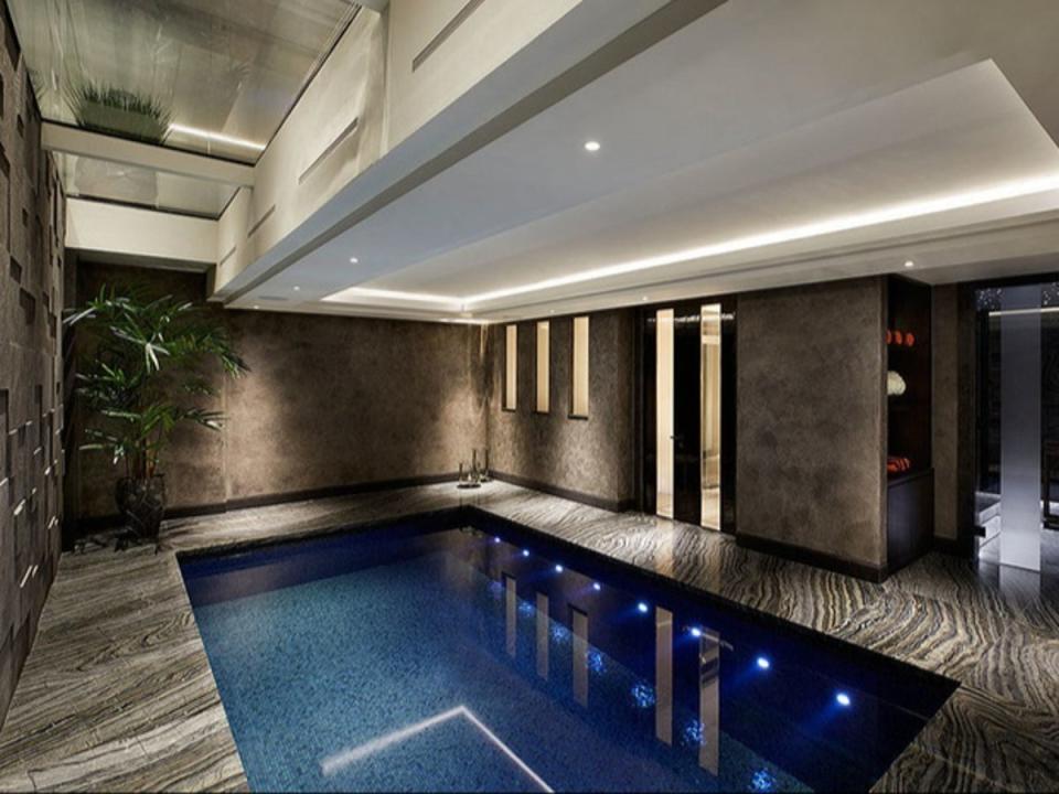 The indoor pool room is finished with Kenya Black Marble (Nest Seekers International)