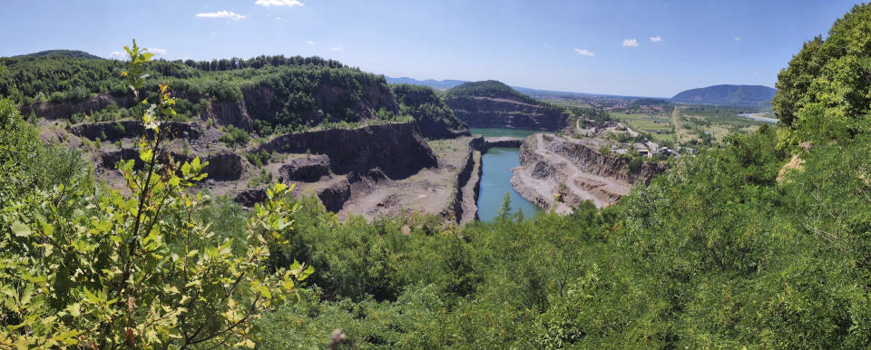 This photo provided by researcher Roman Garba shows the Gostry Verkh area of the Korolevo I archaeological site in western Ukraine in August 2023, with the Korolevo II site behind a body of water. Stone tools found in the area are the earliest evidence of early human presence in Europe, dating back to 1.4 million years ago, according to research published in the journal Nature on Wednesday, March 6, 2024. (Roman Garba via AP)