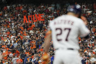 Fans hold up a Houston Astros' Jose Altuve sign during the seventh inning of Game 1 in baseball's World Series between the Houston Astros and the Atlanta Braves Tuesday, Oct. 26, 2021, in Houston. (AP Photo/Ashley Landis)