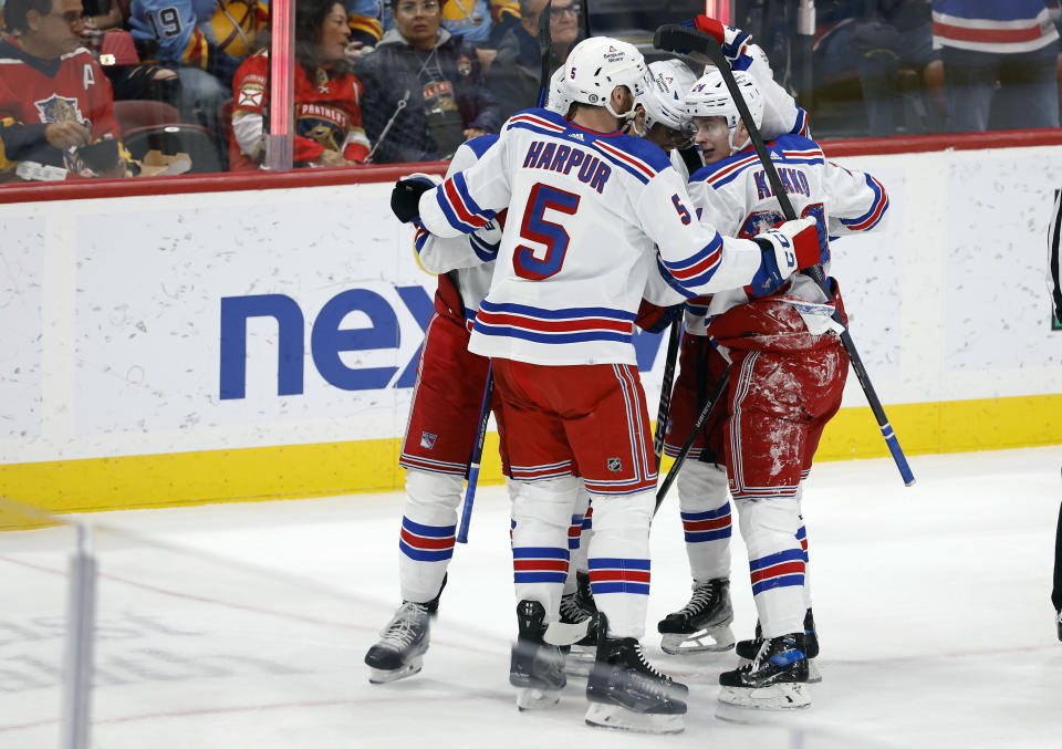 The New York Rangers celebrate after their gaol against the Florida Panthers during the second period of an NHL hockey game Saturday, March 25, 2023, in Sunrise, Fla. (AP Photo/Rhona Wise)