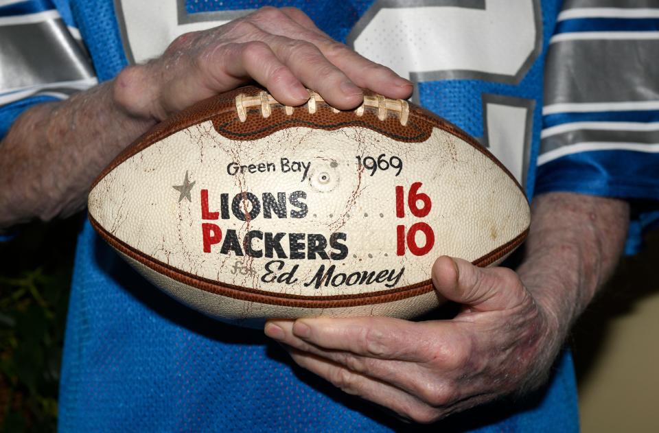 Former Texas Tech and NFL linebacker Ed Mooney holds a game ball he was awarded after a Detroit Lions victory over the Green Bay Packers in 1969. Mooney played for the Lions from 1968-72, the Baltimore Colts in 1973 and the World Football League's Houston Texans in 1974.