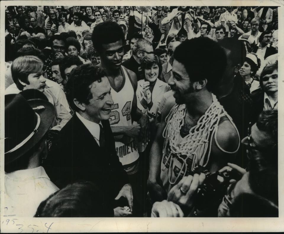 Coach Al McGuire and players Jerome Whitehead (center) and Bernard Toone in 1977 after winning the national title.