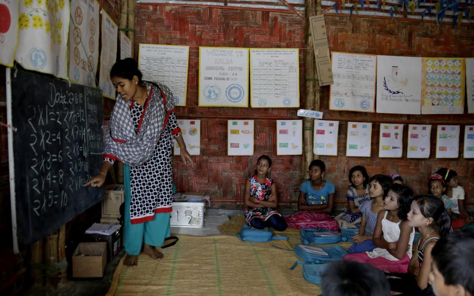 FILE- In this Aug. 27, 2018, file photo, Rohingya refugee children attend a UNICEF run school in Balukhali refugee camp, Bangladesh. Authorities in Bangladesh in partnership with the United Nations will expand educational programs for hundreds of thousands of Muslim Rohingya children living in refugee camps who are currently receiving only basic lessons, officials said Wednesday, Jan. 29, 2020. (AP Photo/Altaf Qadri)