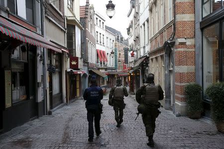 Belgian soldiers patrol a shopping street where tourists frequented in central Brussels, November 22, 2015, after security was tightened in Belgium following the fatal attacks in Paris. REUTERS/Youssef Boudlal