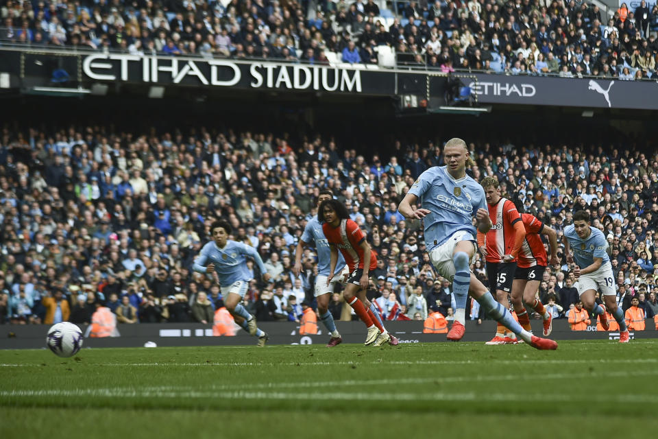 Manchester City's Erling Haaland shoots a penalty kick to score during the English Premier League soccer match between Manchester City and Luton Town at Etihad stadium in Manchester, England, Saturday, April 13, 2024. (AP Photo/Rui Vieira)