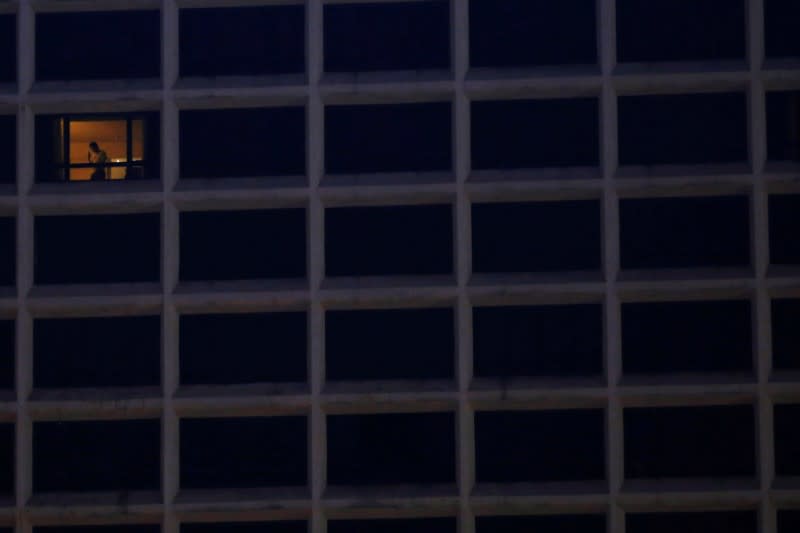 A guest talks on his mobile phone at a hotel, following the coronavirus disease (COVID-19) outbreak, in Hong Kong