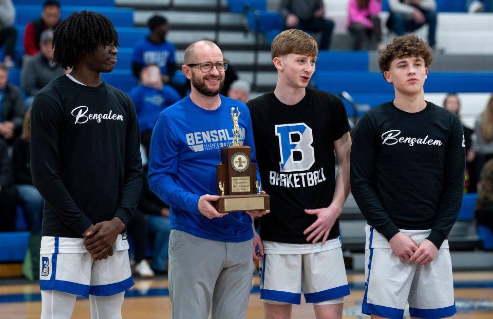 Bensalem head coach Ron Morris and (from left) seniors Nate Cooper, Antonio Morris and Noah Morris with the 2023-24 Suburban One League Patriot Division trophy for winning the division.
Daniella Heminghaus | Bucks County Courier Times