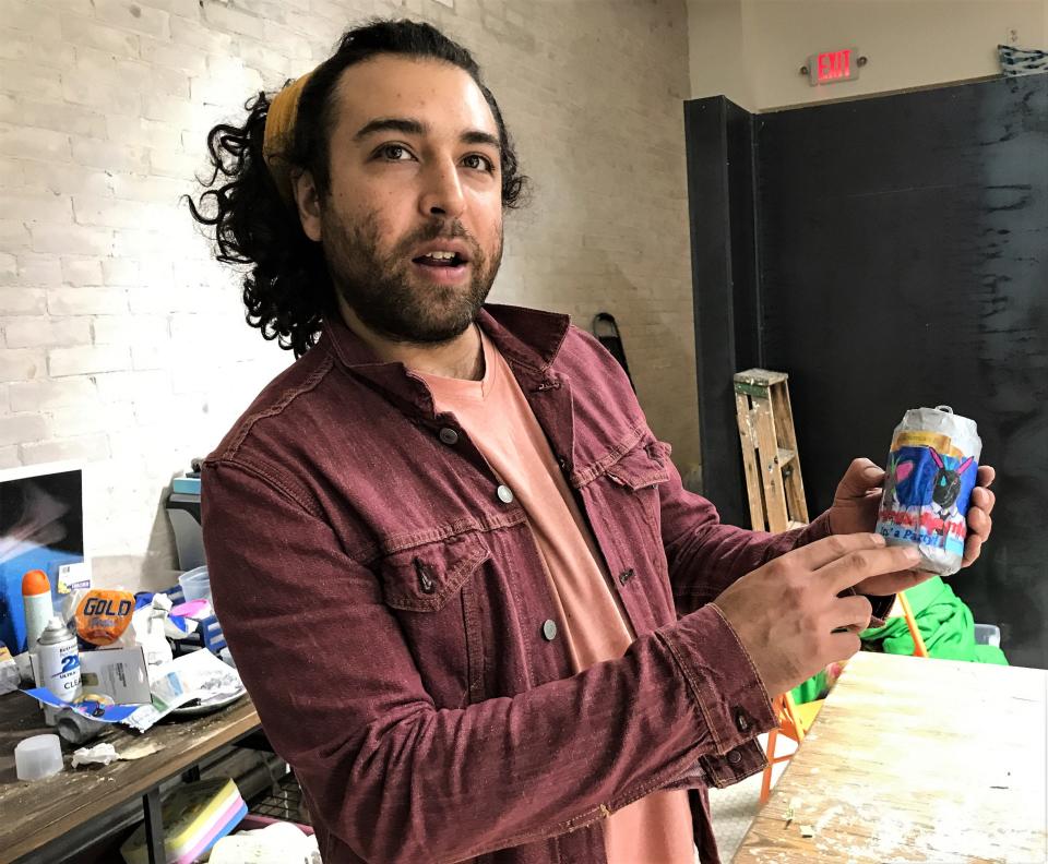 Artist Manuel Urueta displays a label on a beer can that will be part of an exhibit of his, Celina Galicia and Bella Varela's work on Friday, Oct. 15, 2021, at Heavenz Portal, 211 San Antonio Ave.