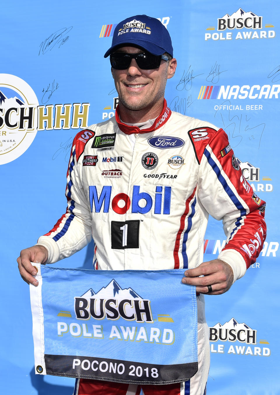 Kevin Harvick poses with the pole award after qualifying for Sunday's NASCAR Cup Series auto race, Saturday, July 28, 2018, in Long Pond, Pa. Harvick's car failed post-qualifying inspection, and he will start at the rear of the field. (AP Photo/Derik Hamilton)