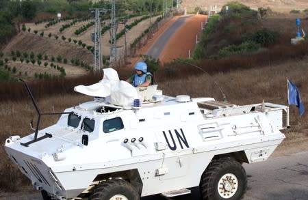 A UN peacekeeper (UNIFIL) patrols the border with Israel in the village of Khiam