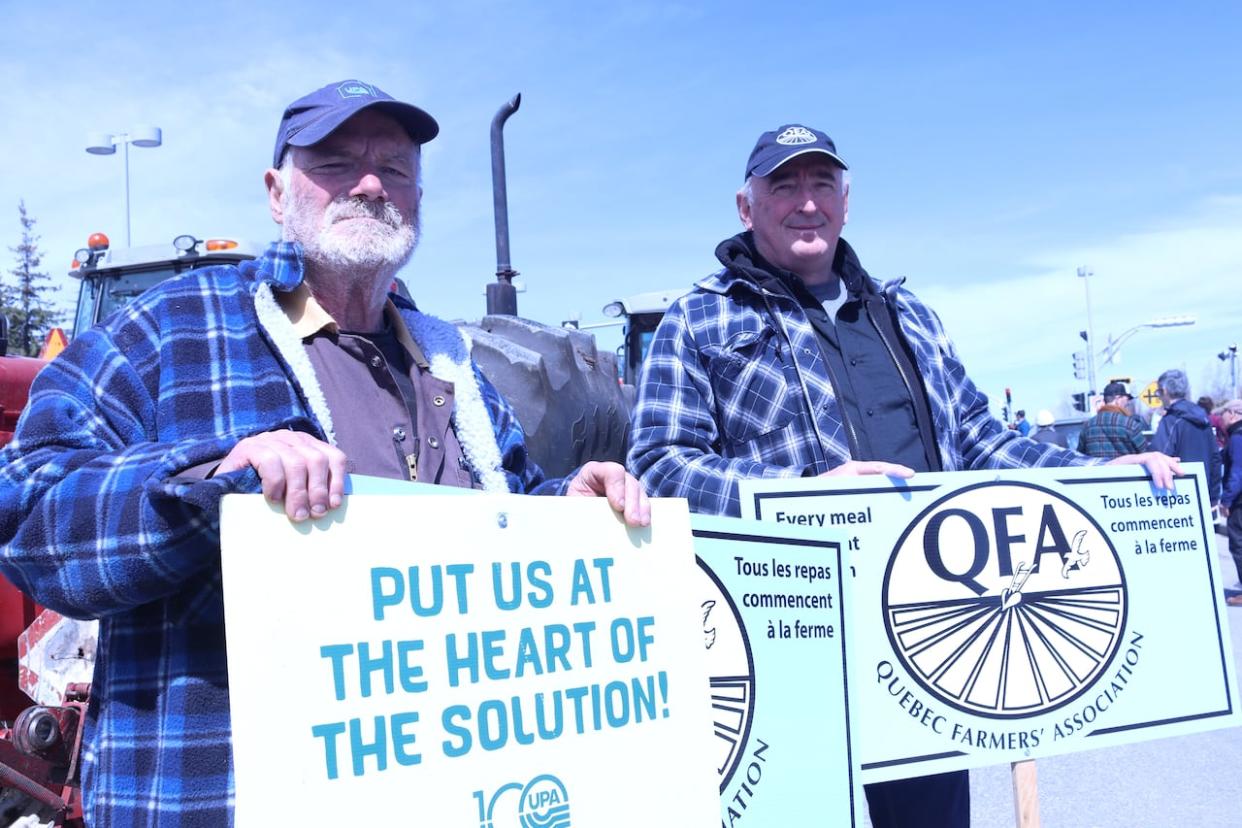 Gib Drury, left, and John McCart, right, are leading members of the Quebec Farmers' Association and were among the 60 or so protesters who took to the streets of Gatineau, Que., Wednesday to demand more protections for their industry. (Zenith Wolfe/CBC - image credit)