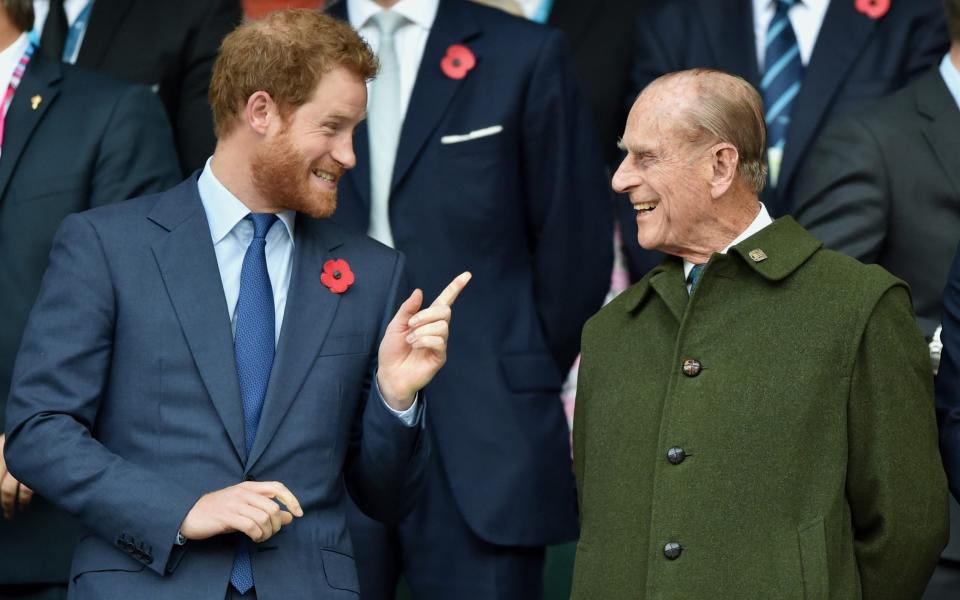 Prince Harry and his grandfather Prince Philip share a joke at the 2015 Rugby World Cup Final at Twickenham - Max Mumby/Indigo/Getty Images Europe