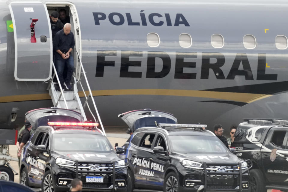 FILE - A handcuffed Domingos Brazao deplanes at the airport in Brasilia, Brazil, March 24, 2024. Brazao and his brother were detained on suspicion of ordering the killing of Rio de Janeiro councilwoman Marielle Franco. Both are allegedly connected to criminal groups, known as militias, which illegally charge residents for various services, including protection. (AP Photo/Eraldo Peres, File)