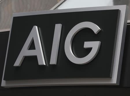 A new sign is displayed over the entrance to the AIG headquarters offices in New York's financial district, January 9, 2013. REUTERS/Brendan McDermid