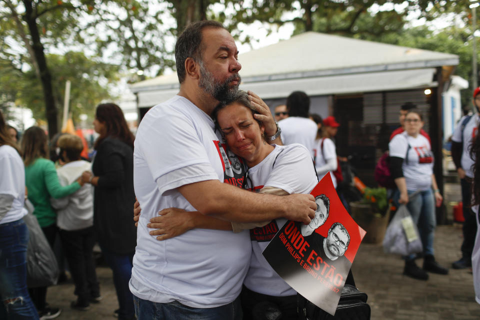 Luis Fabiano and Flavia Farias, relatives of British journalist Dom Phillips´ wife, embrace during a protest following the disappearance, in the Amazon, of Phillips and expert on indigenous affairs Bruno Araujo Pereira, in Copacabana beach, Rio de Janeiro, Brazil, Sunday, June 12, 2022. Federal Police and military forces are carrying out searches and investigations into the disappearance of Phillips and Pereira in the Javari Valley Indigenous territory, a remote area of the Amazon rainforest in Atalaia do Norte, Amazonas state. (AP Photo/Bruna Prado)