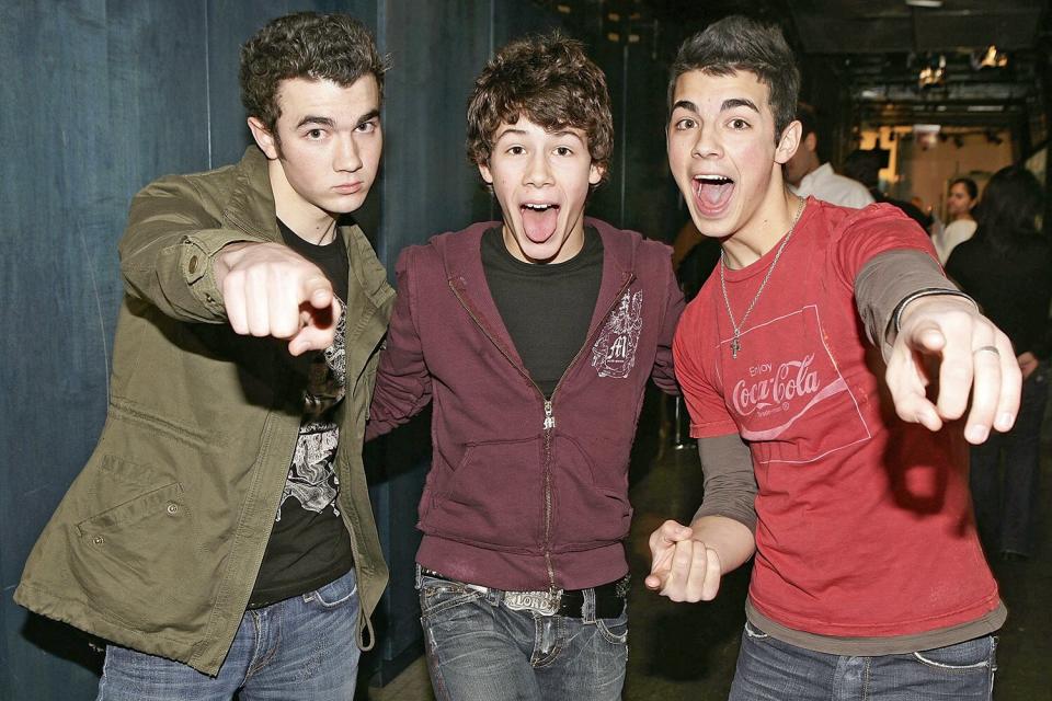 NEW YORK - MARCH 01: (U.S. TABS OUT) (L-R) Kevin, Nicholas, and Joe Jonas of The Jonas Brothers pose for a photo backstage during MTV's Total Request Live at the MTV Times Square Studios March 1, 2006 in New York City. (Photo by Scott Gries/Getty Images)