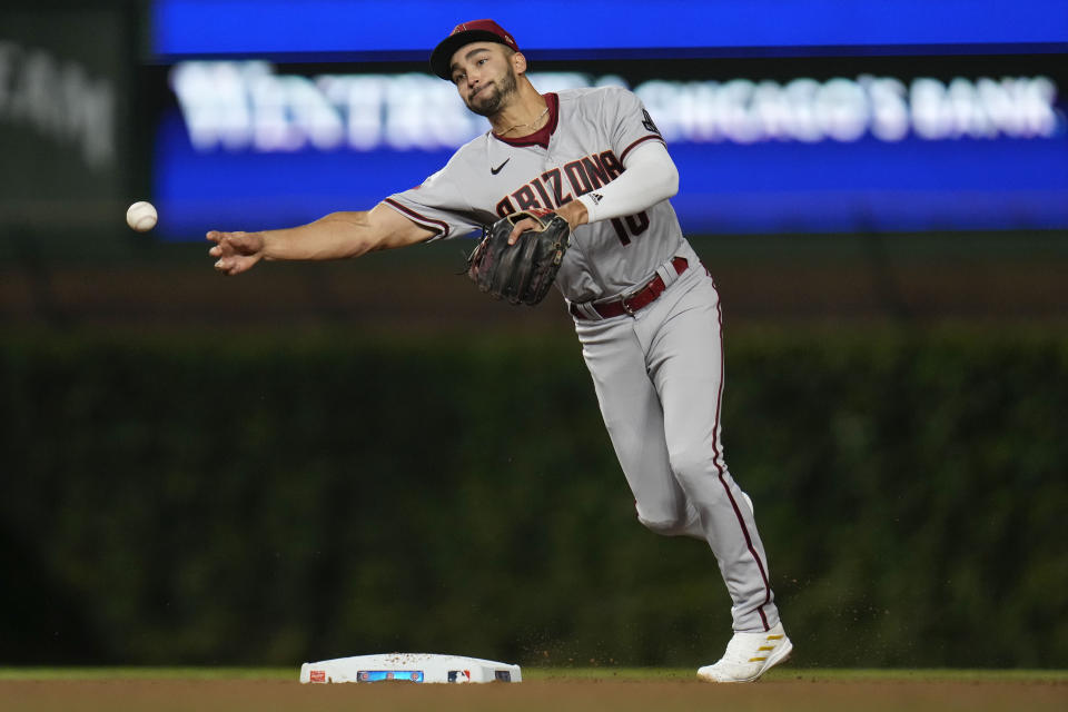 Arizona Diamondbacks shortstop Jordan Lawlar throws to first for the out on Chicago Cubs' Yan Gomes during the fifth inning of a baseball game Thursday, Sept. 7, 2023, in Chicago. (AP Photo/Erin Hooley)