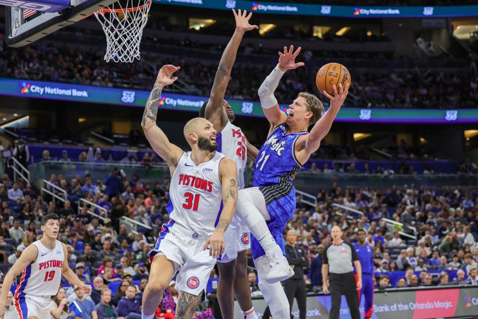 Mar 3, 2024; Orlando, Florida, USA; Orlando Magic center Moritz Wagner (21) goes to the basket against Detroit Pistons guard Evan Fournier (31) and center Isaiah Stewart (28) during the first quarter at KIA Center. Mandatory Credit: Mike Watters-USA TODAY Sports