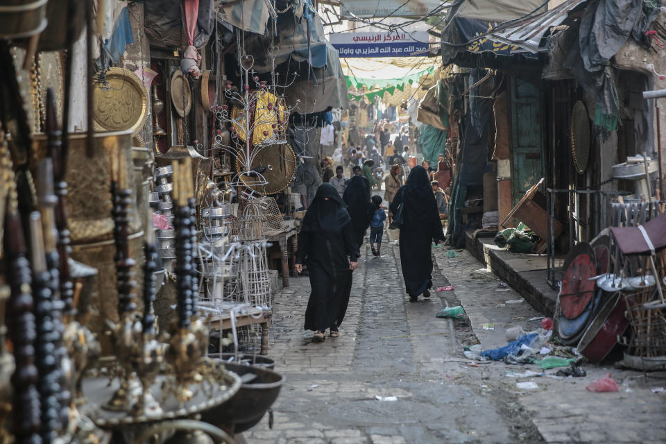 Yemenis walk through market in the old city of Sanaa, Yemen, Tuesday, Dec. 11, 2018. (AP Photo/Hani Mohammed)