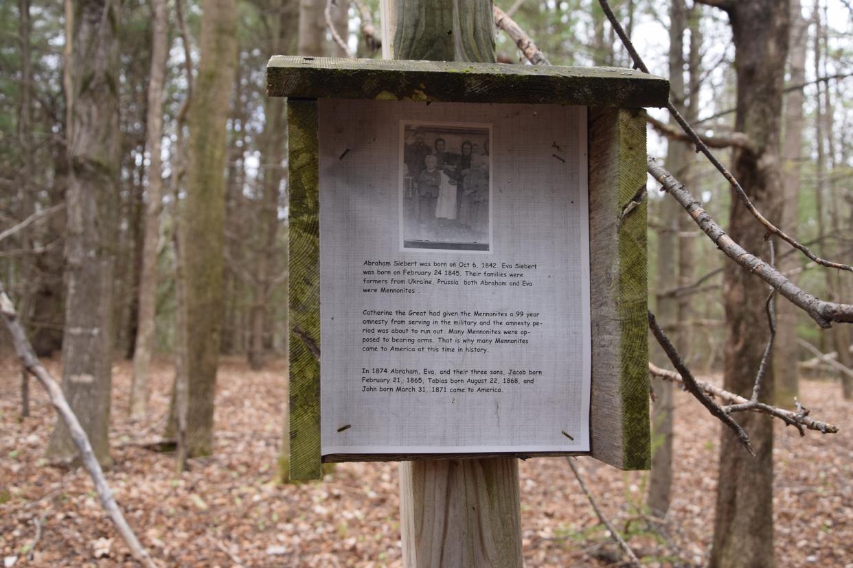 A sign in the NCMC Natural Area features a photo of some of the Sieberts and information regarding them fleeing Prussia.