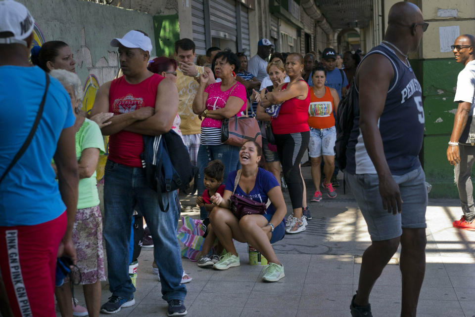 FILE - In this April 17, 2019 file photo, people wait in line to buy chicken at a government-run grocery store in Havana, Cuba. The Cuban government said Friday, May 10, that it will begin widespread rationing of chicken, eggs, rice, beans, soap and other basic products in the face of a grave economic crisis. (AP Photo/Ramon Espinosa, File)