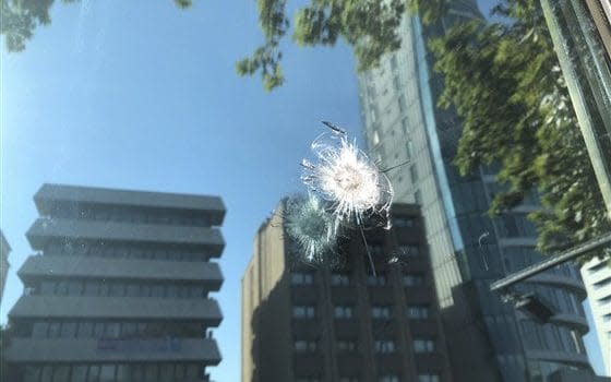 A window bears the mark of a bullet fired at the US embassy in Ankara - AP/Burhan Ozbilici