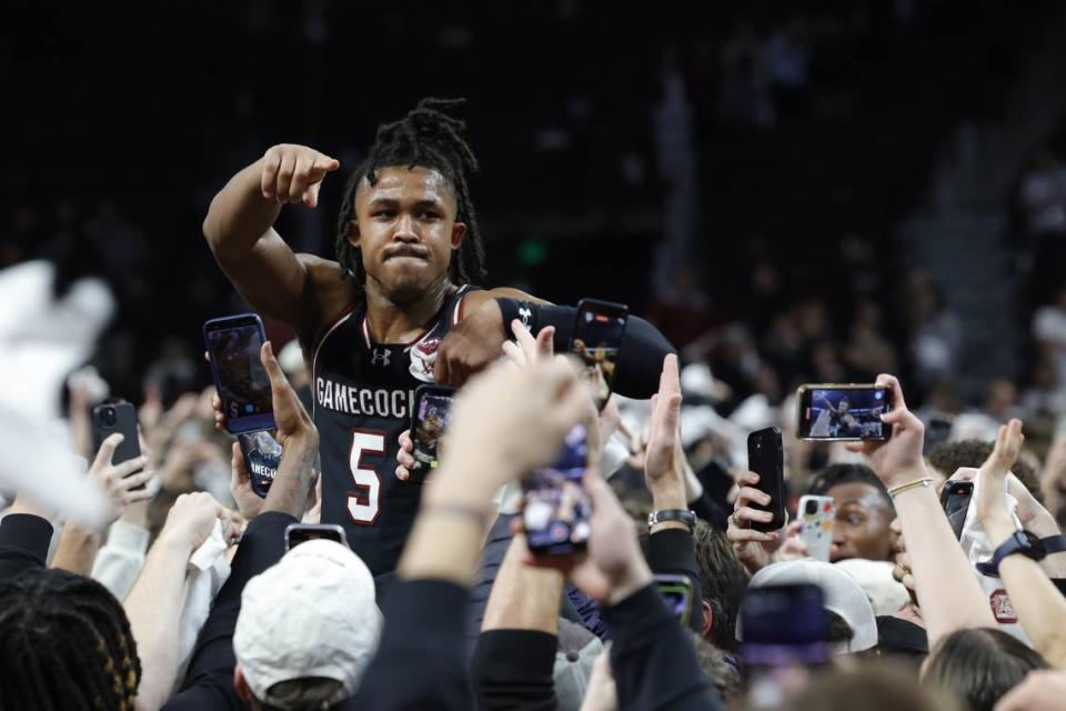 South Carolina’s Meechie Johnson celebrates with fans after the upset win over Kentucky.